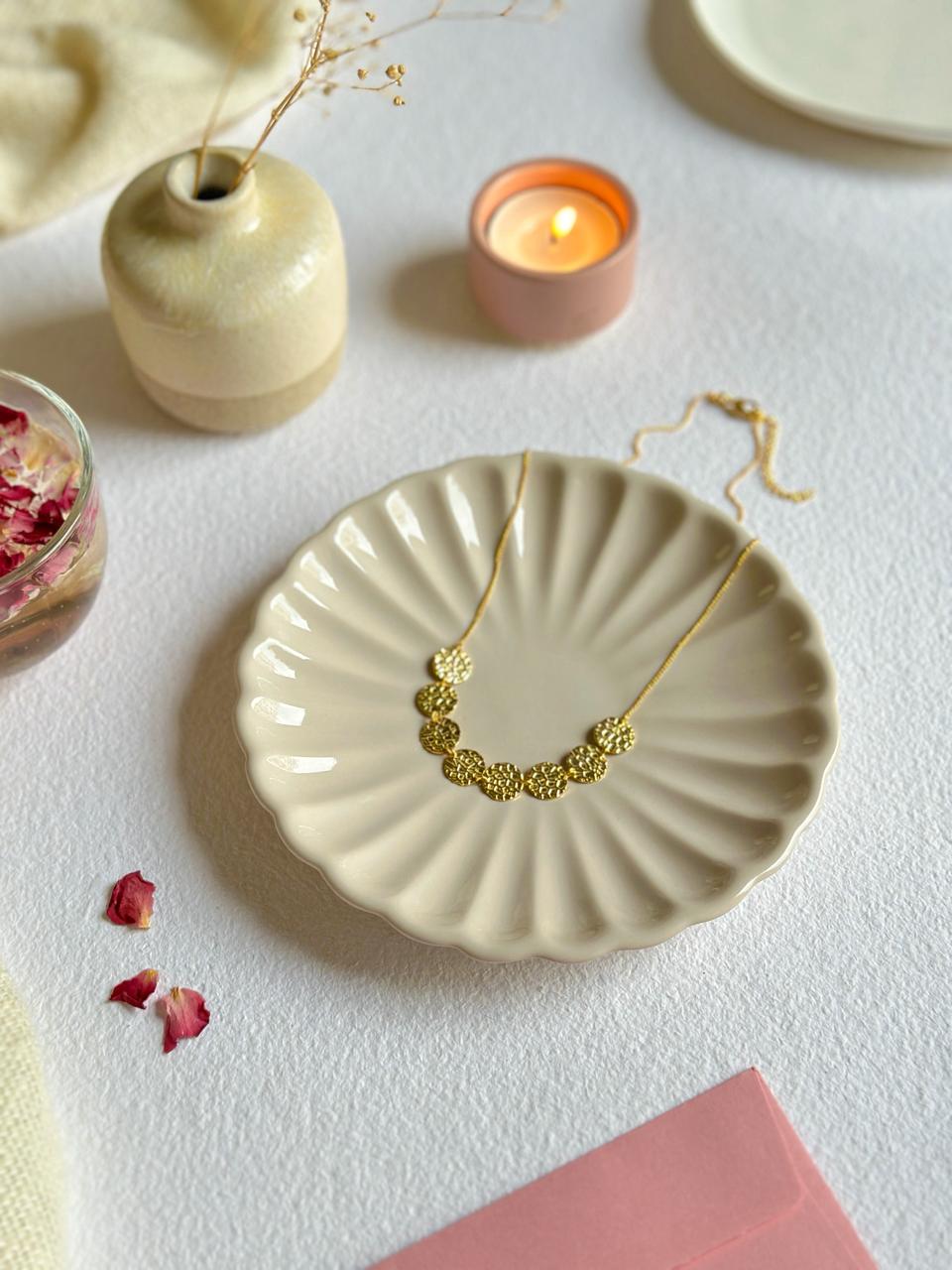 Dainty brass necklace styled in a lifestyle setup